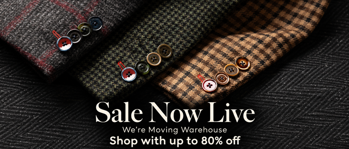 Three folded plaid and herringbone wool shirts or shirtsleeves in brown, green, and red tones are arranged on a dark textured surface, each decorated with decorative buttons. Large text reads 'HOLLAND ESQUIRE' at the top and 'Sale Now Live' with a 'SHOP SALE' button at the bottom.